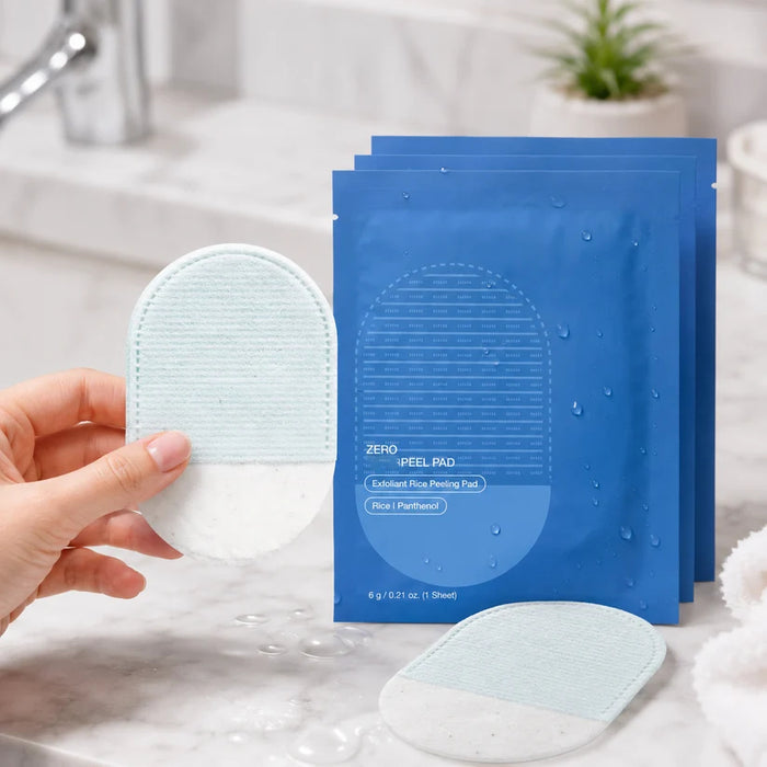 Hand holding a dual-sided exfoliating pad