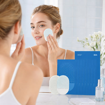 Person gently using an exfoliating pad on the cheek